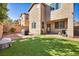 This backyard features a manicured lawn, brick pavers, and outdoor lighting, perfect for entertaining at 854 Earth Luster Rd, Las Vegas, NV 89178