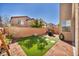 Backyard with artificial turf, a low brick wall, and mature landscaping at 854 Earth Luster Rd, Las Vegas, NV 89178