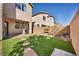 This backyard features a manicured lawn, brick pavers, and outdoor lighting, perfect for entertaining at 854 Earth Luster Rd, Las Vegas, NV 89178