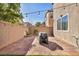 A fully fenced backyard with pavers, artificial grass, and a covered grill provides a private outdoor retreat at 854 Earth Luster Rd, Las Vegas, NV 89178