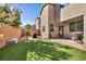 This backyard features a manicured lawn, brick pavers, and outdoor lighting, perfect for entertaining at 854 Earth Luster Rd, Las Vegas, NV 89178