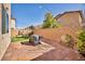 A fully fenced backyard with pavers, artificial grass, and a covered grill provides a private outdoor retreat at 854 Earth Luster Rd, Las Vegas, NV 89178