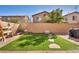 Private backyard featuring artificial turf, a patio, and mature desert landscaping at 854 Earth Luster Rd, Las Vegas, NV 89178