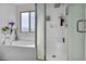 Bathroom featuring a soaking tub next to a glass shower and a plant on the ledge at 854 Earth Luster Rd, Las Vegas, NV 89178