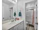 Bright, clean bathroom featuring a well-lit vanity, a single sink, and a combined tub and shower with a white tile surround at 854 Earth Luster Rd, Las Vegas, NV 89178