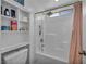 Bright bathroom featuring a combined tub and shower, complemented by a built-in shelving unit for optimal bathroom storage at 854 Earth Luster Rd, Las Vegas, NV 89178