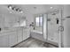 Bathroom featuring dual sinks, soaking tub, glass shower, white cabinetry, and wood-look tile flooring at 854 Earth Luster Rd, Las Vegas, NV 89178