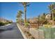 Street view of Stonegate community entrance with lush palm trees and beautiful landscaping at 854 Earth Luster Rd, Las Vegas, NV 89178