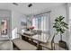 Dining room with a modern table, bench seating, sheer curtains, and natural light at 854 Earth Luster Rd, Las Vegas, NV 89178