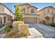 Two-story home featuring a two-car garage, a large driveway, and well-maintained landscaping at 854 Earth Luster Rd, Las Vegas, NV 89178