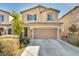 Inviting two-story home with stone accents, a two-car garage, and a well-maintained front yard at 854 Earth Luster Rd, Las Vegas, NV 89178