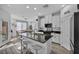 Well-lit kitchen island featuring a granite countertop, barstool seating, and modern white cabinetry at 854 Earth Luster Rd, Las Vegas, NV 89178