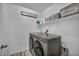 Efficient laundry room with modern washer and dryer, complemented by storage shelves and stylish organization solutions at 854 Earth Luster Rd, Las Vegas, NV 89178