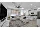 Open-concept living room featuring a ceiling fan, tile floors, a comfortable sectional, and seamless flow to the kitchen at 854 Earth Luster Rd, Las Vegas, NV 89178