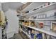 Organized walk-in pantry with open shelving stocked with food items and storage baskets for optimal kitchen storage solutions at 854 Earth Luster Rd, Las Vegas, NV 89178