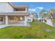 This backyard features a covered patio, a green lawn, and block wall fence at 8701 Robinson Ridge Dr, Las Vegas, NV 89117