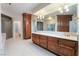 Bathroom featuring a long vanity, cabinetry, and a walk-in shower at 8701 Robinson Ridge Dr, Las Vegas, NV 89117