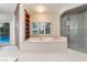 Bathroom with a soaking tub, shower, and natural light at 8701 Robinson Ridge Dr, Las Vegas, NV 89117