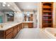 Bathroom featuring a dual vanity, built-in shelves, and natural light at 8701 Robinson Ridge Dr, Las Vegas, NV 89117