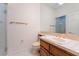 Modern bathroom with a wooden vanity, toilet, sink, and glass-door shower at 8701 Robinson Ridge Dr, Las Vegas, NV 89117