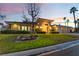 Attractive exterior featuring lush landscaping, a circular driveway, and a well-maintained lawn at 8701 Robinson Ridge Dr, Las Vegas, NV 89117