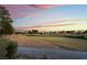 Scenic golf course with winding green spaces, sand and a colorful sunset background at 8701 Robinson Ridge Dr, Las Vegas, NV 89117