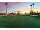 Golf course putting green featuring a flag, sand trap, and picturesque sky at dusk at 8701 Robinson Ridge Dr, Las Vegas, NV 89117