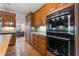 Close up of kitchen stainless steel appliances and wood cabinets at 8701 Robinson Ridge Dr, Las Vegas, NV 89117