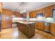 Spacious kitchen featuring a kitchen island, wood cabinets, and stainless steel appliances at 8701 Robinson Ridge Dr, Las Vegas, NV 89117