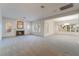 Spacious living room with fireplace, large windows, plantation shutters, and neutral carpet at 8701 Robinson Ridge Dr, Las Vegas, NV 89117