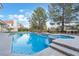 Backyard pool with blue water, complimented by mature trees and greenery at 8701 Robinson Ridge Dr, Las Vegas, NV 89117