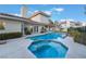 Backyard spa flows into the pool with lush landscaping near a covered patio at 8701 Robinson Ridge Dr, Las Vegas, NV 89117