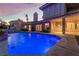 The backyard features a pool, covered patio, and professional landscaping at 8701 Robinson Ridge Dr, Las Vegas, NV 89117