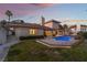 An elegant pool provides a striking focal point in the backyard, enhanced by lush green grass at 8701 Robinson Ridge Dr, Las Vegas, NV 89117