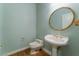 Powder room featuring a pedestal sink and decorative mirror at 8701 Robinson Ridge Dr, Las Vegas, NV 89117