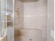 Walk-in shower with tiled walls, bench, and glass door at 8701 Robinson Ridge Dr, Las Vegas, NV 89117