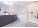 Well-lit bathroom featuring double sinks, bathtub, and a glass-enclosed shower at 10139 Palazzo Marcelli Ct, Las Vegas, NV 89147