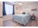 Cozy bedroom featuring a ceiling fan, and a comfortable bed with a side table at 10139 Palazzo Marcelli Ct, Las Vegas, NV 89147