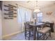 Dining room featuring a large table with a gray wood grain finish and decorative shelving at 10139 Palazzo Marcelli Ct, Las Vegas, NV 89147