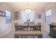 Dining room featuring a large table with a gray wood grain finish and decorative shelving at 10139 Palazzo Marcelli Ct, Las Vegas, NV 89147