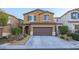 Two-story home featuring a 2-car garage, desert landscaping, and a charming, covered front entryway at 10139 Palazzo Marcelli Ct, Las Vegas, NV 89147