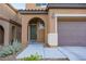 Close up shot of a covered front porch and front door framed by an archway and pillars at 10139 Palazzo Marcelli Ct, Las Vegas, NV 89147