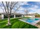 Stunning backyard features lush lawn, large pool, and covered patio perfect for outdoor entertaining at 10313 Orkiney Dr, Las Vegas, NV 89144