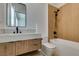 Modern bathroom featuring a wood vanity with white countertop and a bathtub with a shower at 10313 Orkiney Dr, Las Vegas, NV 89144