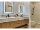 Bathroom featuring a double vanity with modern lighting, black fixtures and a glass shower enclosure at 10313 Orkiney Dr, Las Vegas, NV 89144