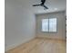 Clean and bright bedroom featuring wood-look flooring, plantation shutters, and a minimalist style at 10313 Orkiney Dr, Las Vegas, NV 89144