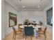 Dining room with modern light fixture, marble table, and wood floors at 10313 Orkiney Dr, Las Vegas, NV 89144