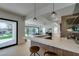 Kitchen with quartz countertop bar that opens up to the backyard with pool view at 10313 Orkiney Dr, Las Vegas, NV 89144