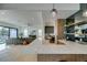 Bright, open-concept kitchen featuring an expansive marble countertop, modern lighting, and seamless flow into the living area at 10313 Orkiney Dr, Las Vegas, NV 89144