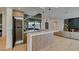 Modern kitchen with wood cabinets, marble countertops, a built-in wine fridge, and stylish pendant lighting at 10313 Orkiney Dr, Las Vegas, NV 89144